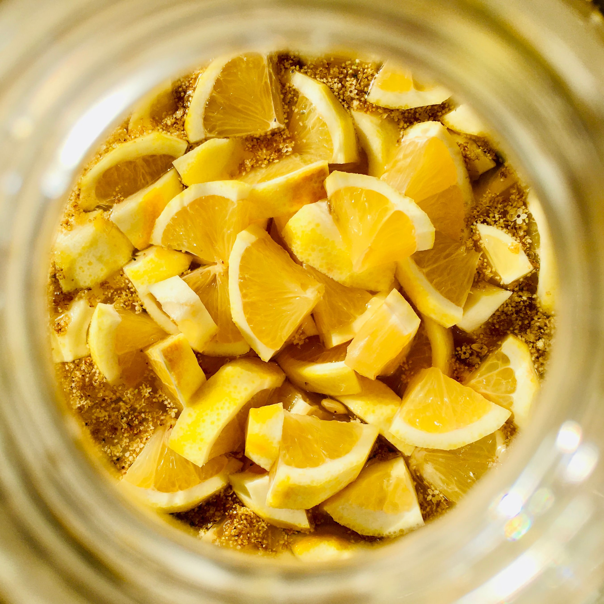 Lemon wedges fermenting with jaggery inside a glass jar